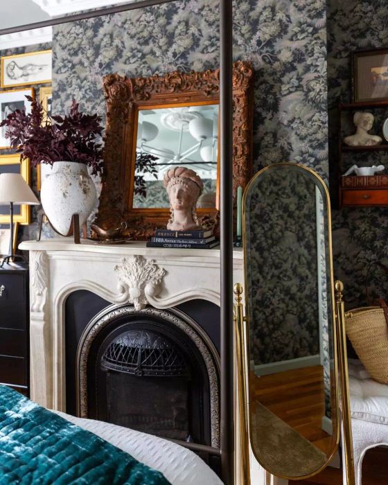 A fireplace mantel adorned with artificial branches.