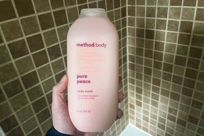 A hand holding the Method Body Wash