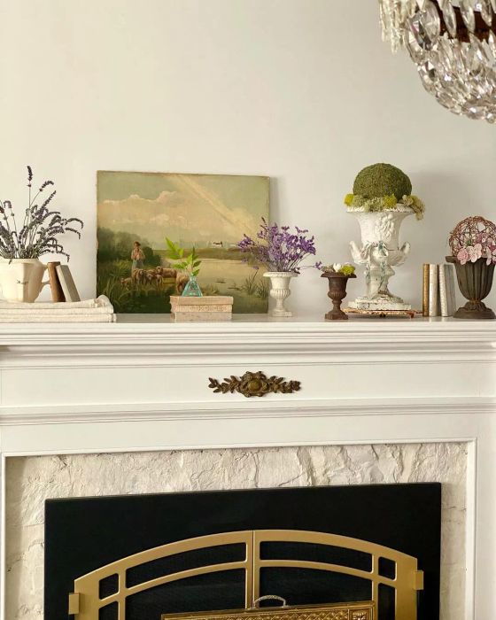 A small collection of urns arranged on the mantel.