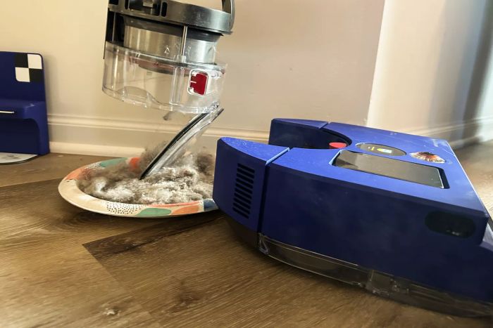 The bin of the Dyson 360 Vis Nav Robot Vacuum emptied onto a paper plate.