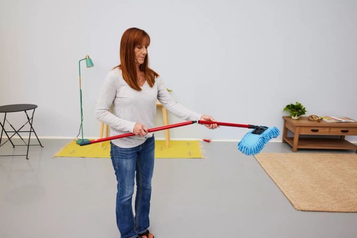 A person assembles the O-Cedar Dual-Action Microfiber Sweeper Dust Mop