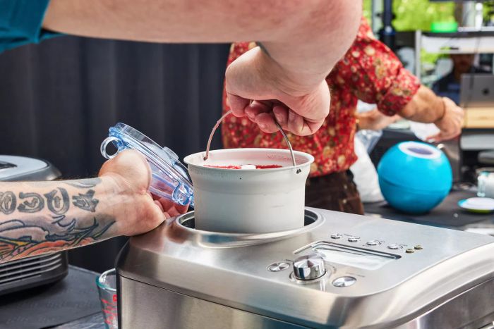 Hand lifting a bucket of sorbet from the Breville The Smart Scoop Ice Cream Maker
