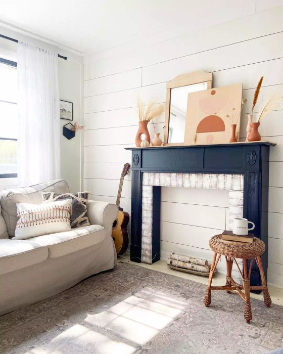 A fireplace mantel styled in boho fashion.