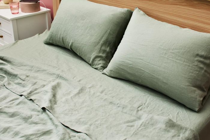 A bed styled with the Casaluna 100% Washed Hemp Solid Sheet Set and pillows.