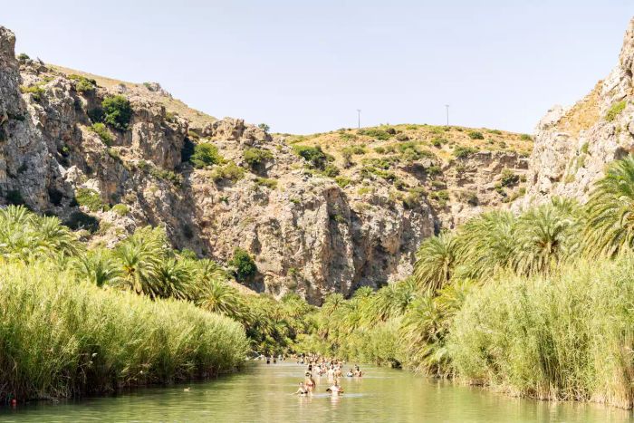People enjoying a swim in a lagoon in Crete